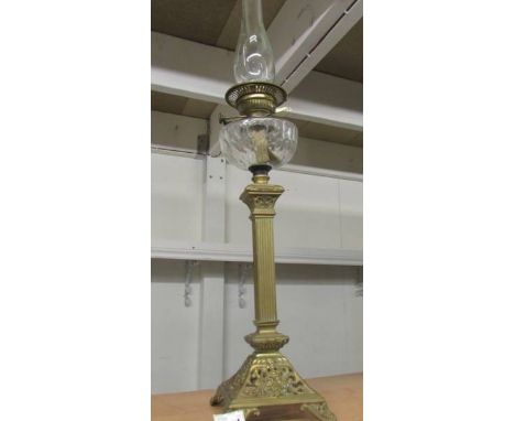 A Victorian brass column oil lamp with cut glass font.