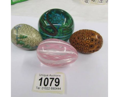 A Nailsea glass egg, a carved egg (a/f), a cloisonne egg and a glass paperweight.