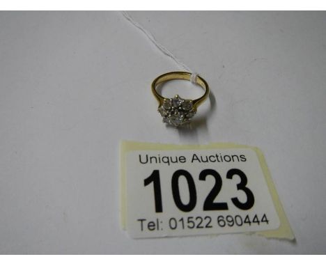 A 1 carat diamond floral ring set in 18ct gold, size K.