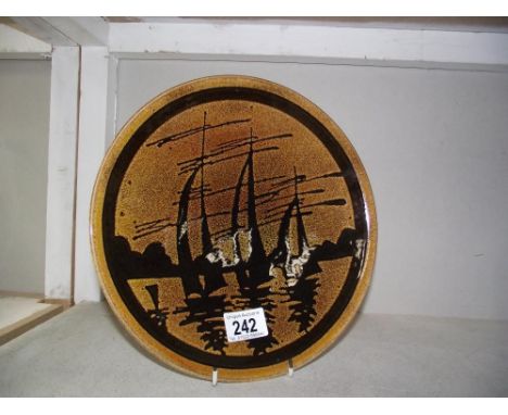 A Poole pottery plate yacht on sea