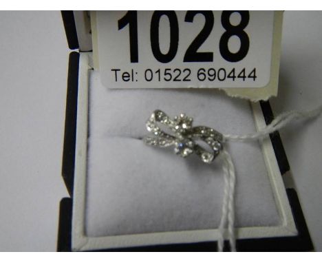 An 18ct white gold and diamond bow ring, size K.