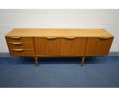 A MCINTOSH TEAK SIDEBOARD, double cupboard doors enclosing a shaped shelf, besides a bank of three drawers, the top drawer th