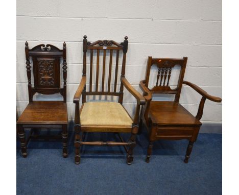 A REPRODUCTION OAK OPEN ARM CHAIR with scrolls to top rail (a little rickety), an Edwardian mahogany commode chair (missing b