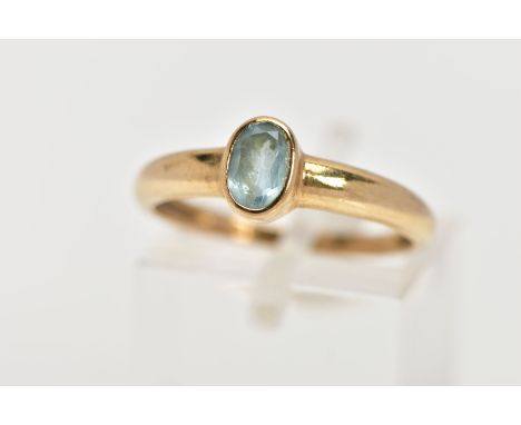 A 9CT GOLD TOPAZ RING, designed as an oval blue topaz within a collet setting, to the plain band, 9ct hallmark for Birmingham