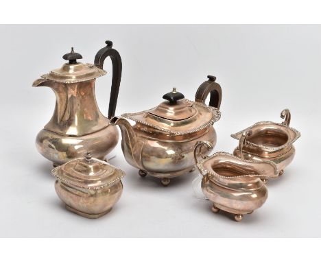 A SILVER FIVE-PIECE TEA SET, to include a teapot and hot water jug each with a wooden scroll handle and finial, gadrooned and