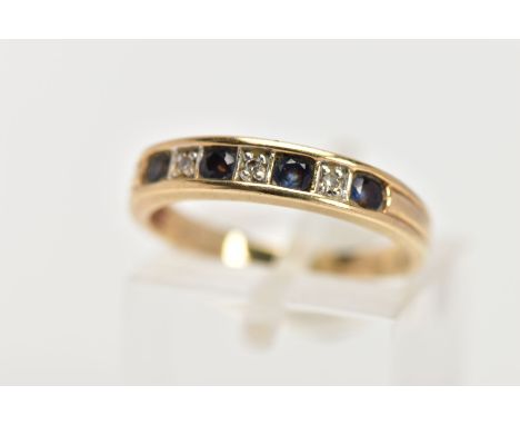 A 9CT GOLD SEVEN STONE SAPPHIRE AND DIAMOND RING, the line of four circular cut sapphires interspaced by single cut diamonds,