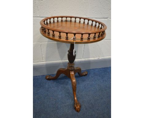 A REPRODUCTION MAHOGANY OCCASIONAL TABLE, with a spindled gallery, to a tripod base, on ball and claw feet, diameter 47cm x h