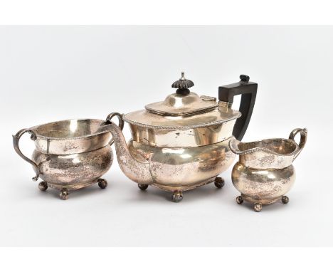 AN EARLY 20TH CENTURY THREE PIECE SILVER TEA SET, to a plain polished teapot, engraved monogram to the side, ebonised finial 