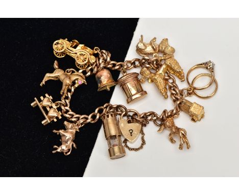 A 9CT GOLD CHARM BRACELET, curb link bracelet, suspending eleven charms in forms such as a horse set with a ruby eye hallmark