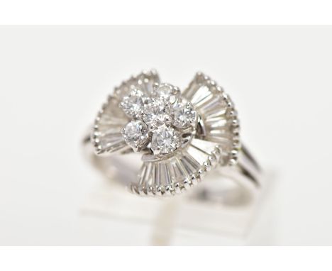 A MODERN DIAMOND FANCY RING, centring on a cluster of round brilliant cut diamonds, enclosed within a fan boarder of baguette