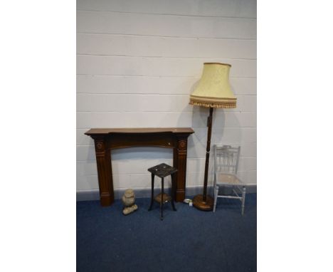 AN OAK FIRE SURROUND, width 132cm x height 108cm, along with a stained beech standard lamp, with a lead base and fabric shade