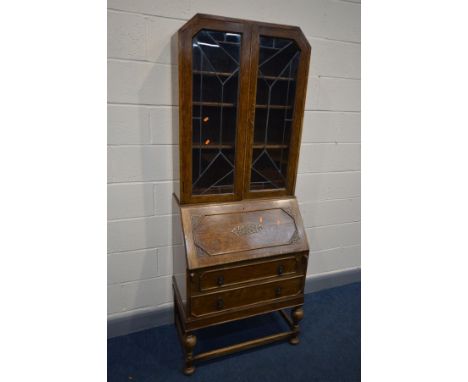 A EARLY TO MID 20TH CENTURY OAK BUREAU BOOKCASE, the top section with Art Deco lead glazed doors, width 76cm x depth 46cm x h