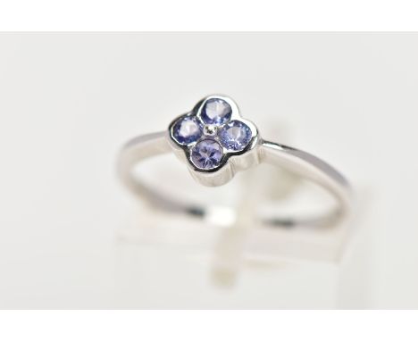 A 9CT WHITE GOLD TANZANITE DRESS RING, designed as four circular cut tanzanites within a quatrefoil collet setting, 9ct hallm