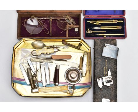 A SELECTION OF ITEMS, to include a tin of assorted fruit knives, a white metal teaspoon and butter knife, a cigar cutter, a C