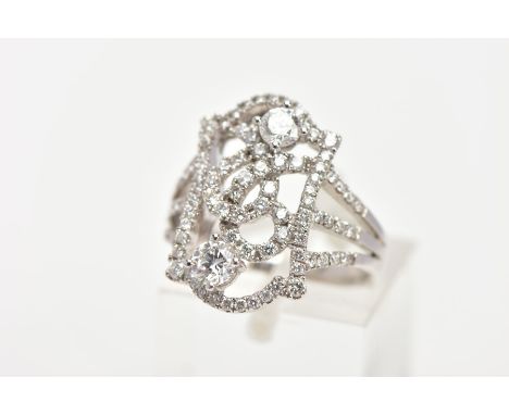 A MODERN DIAMOND FANCY RING, designed as an open rectangular head of scroll design with two larger modern round brilliant cut