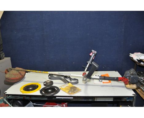 A KAWASAKI KBH26A PETROL STRIMMER with manual, strap and some spare parts (engine pulls freely and starts first time)