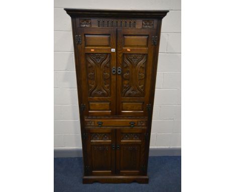 AN OLD CHARM COCKTAIL CABINET, the top section with double doors enclosing two glass shelves and a mirror, above a glass top 