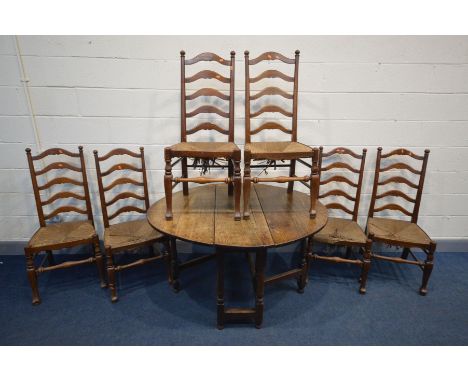 A GEORGIAN OAK GATE LEG TABLE, open length 128cm x closed length 39cm x depth 113cm x height 72cm and six rush seated ladder 