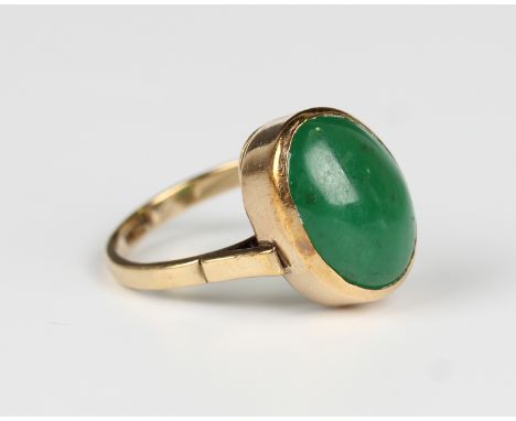 A gold and oval cabochon jade solitaire ring, detailed '9ct', weight 6.9g, ring size approx R1/2.Buyer’s Premium 29.4% (inclu