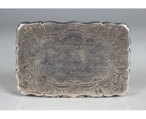 An early Victorian silver shaped rectangular snuff box, the hinged lid presentation inscribed, otherwise with foliate scroll 