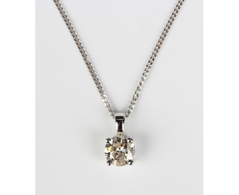 A white gold and diamond single stone pendant, claw set with a circular cut diamond, with a silver neckchain, detailed '925 I