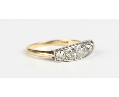 A gold and diamond five stone ring, mounted with a row of cushion cut diamonds graduating in size to the centre stone, detail