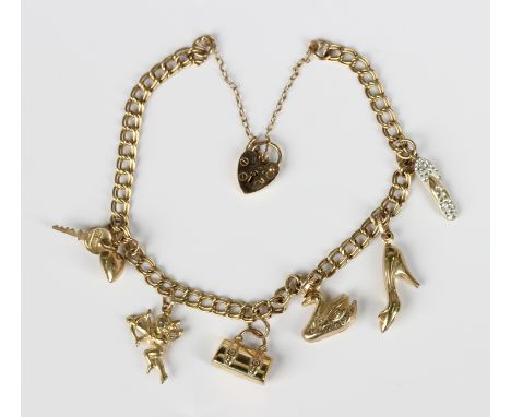 A 9ct gold twin curblink charm bracelet with a 9ct gold heart shaped padlock clasp, fitted with six gold charms, including a 