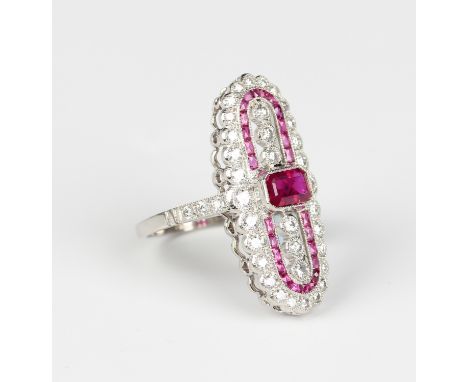A platinum, treated ruby and diamond oval panel ring, collet set with the principal cut cornered rectangular step cut treated