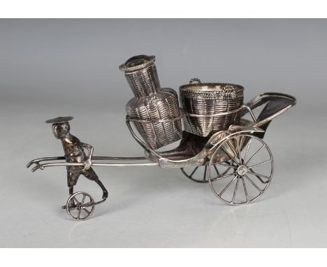 A Chinese sterling silver condiment stand, modelled as a man and rickshaw, maker's mark for Tackhing of Hong Kong, weight 75.