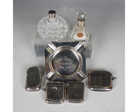 A late Victorian silver vesta case, engraved with scrolls, Birmingham 1897, two similarly decorated silver vesta cases, a sil