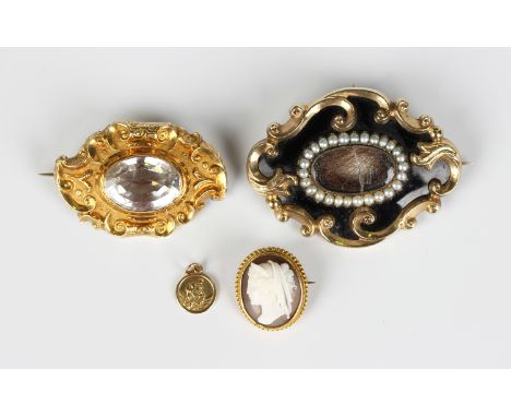 A Victorian gold and rock crystal shaped oval brooch, mounted with the oval cut rock crystal within a scrolled surround, unma