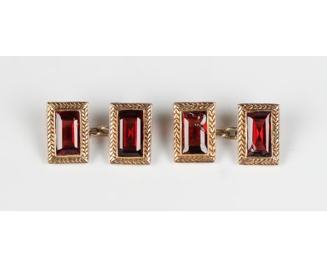 A pair of gold and garnet rectangular cufflinks, each mounted with a rectangular step cut garnet within decorated borders, un