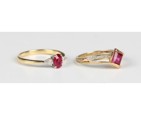 An 18ct gold, ruby and diamond three stone ring, claw set with the oval cut ruby between two pear shaped diamonds, weight 2.7