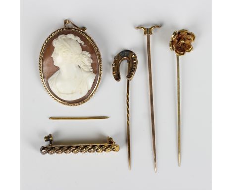 A gold mounted oval shell cameo brooch, carved as a portrait of a lady within a ropetwist wirework surround, detailed '9ct', 