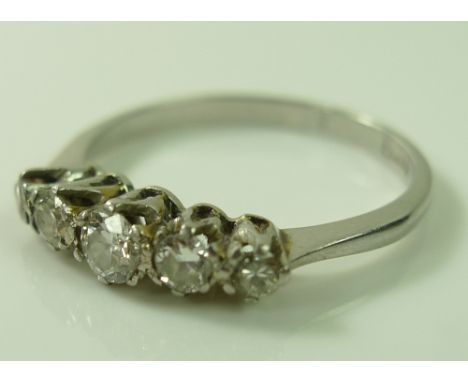 A platinum and diamond five stone ring, largest central stone approximately 3.2mm diameter, total diamond weight approximatel