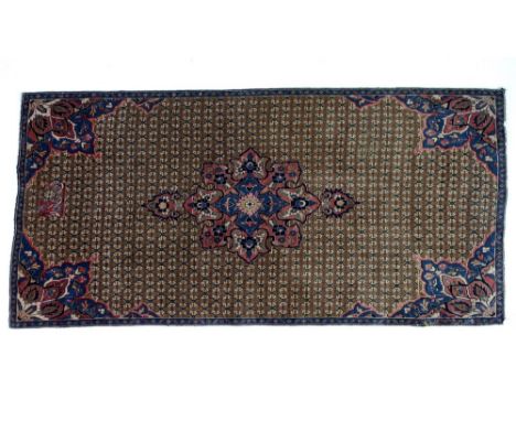 A Hamadan rug with olive green ground, central floral medallion and corners in dark blue, red, cream and black, the field pat