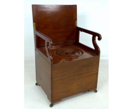A mahogany commode, circa 1900, with brass fittings, lift lid revealing carved scroll arms folding outwards and locking into 
