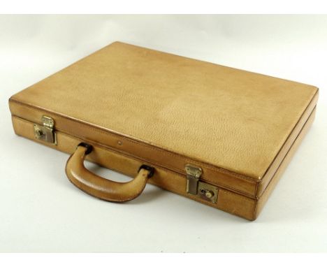 A light tan pigskin narrow briefcase, of conventional form, with compartmental interior, 44 by 33 by 7.6cm.