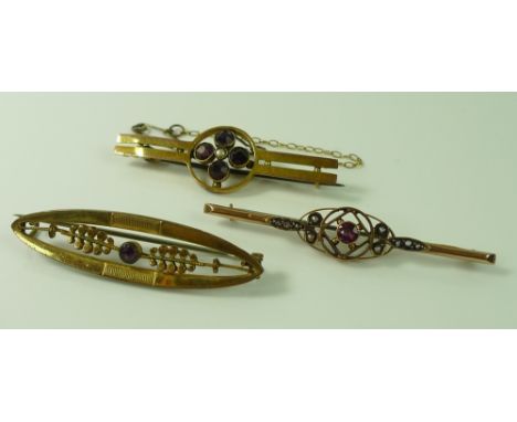 A group of three bar brooches, comprising a 9ct gold ruby and seed pearl brooch, a 9ct gold, amethyst and seed pearl brooch a