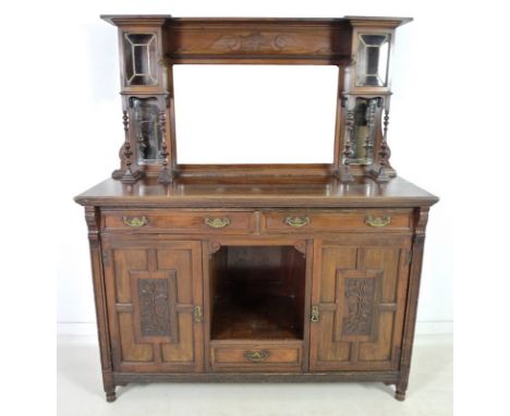 An Edwardian mahogany sideboard, mirrored back with bevelled plates, two small lead glazed cupboards on four turned spindles,