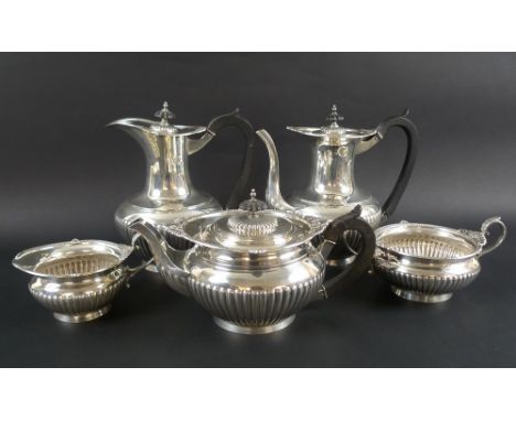 An Edwardian and later silver harlequin tea and coffee service, with gadrooned bodies and rims intertwined with daisies, ebon