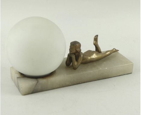 An Art Deco style figural table lamp, with gold lacquer finish, modelled as a young lady lying nude with her chin resting on 