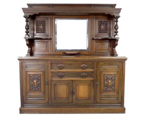 A large Victorian oak dresser, mirror and shaped shelves to back, with baluster columns supporting a dentil moulded cornice s