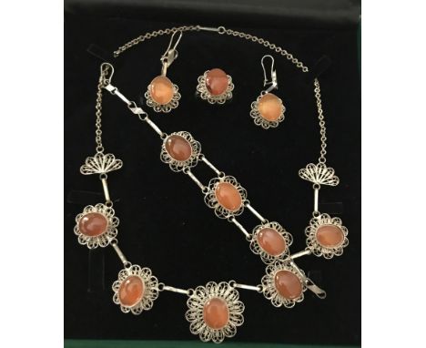 Comprising necklace, bracelet, earrings and ring. 
