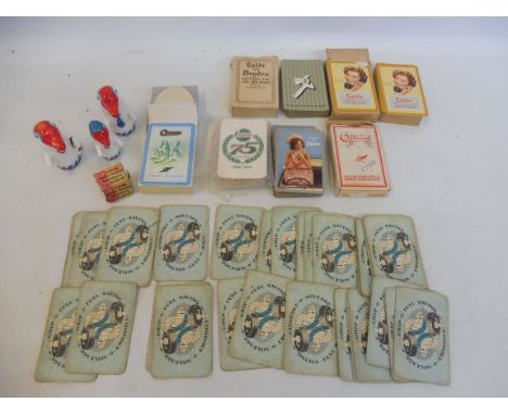 A quantity of playing cards all with motoring advertising including Michelin and Exide, plus two Fina porcelain promotional d