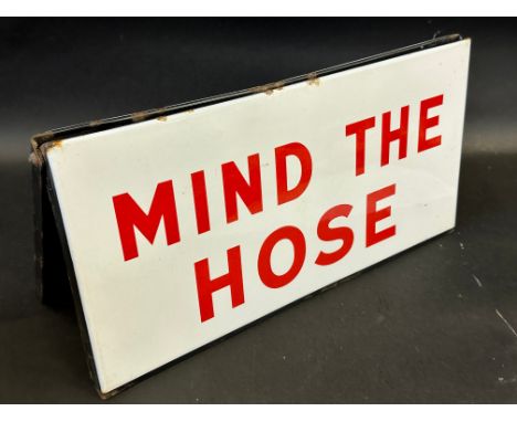 A 'Mind The Hose' folding two piece delivery tanker driver's enamel sign, 18 x 9".
