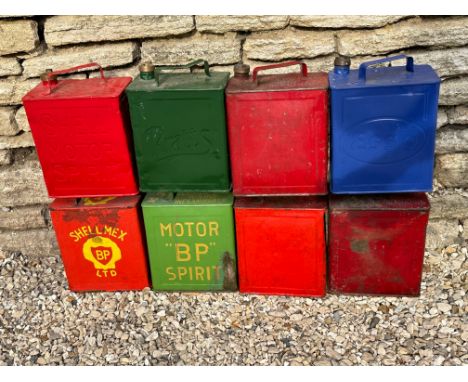 Eight two gallon petrol cans including BP Motor Spirit etc.