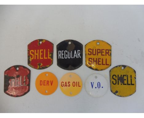 A tray of enamel brand plaques from tanks or pumps, including Shell, also three circular plastic tags.