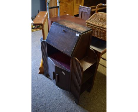 MID-20TH CENTURY SMALL PROPORTIONED BUREAU WITH DROP FRONT AND OPEN SHELF OVER TWO CUPBOARD DOORS FLANKED EITHER SIDE BY OPEN