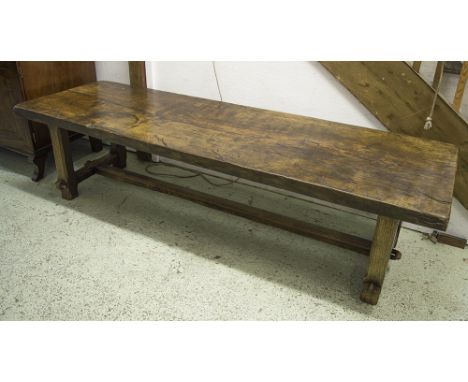 LOW TABLE/BENCH, oak, the single plank top over reduced stretchered supports, 202cm L x 64cm W x 51cm H.